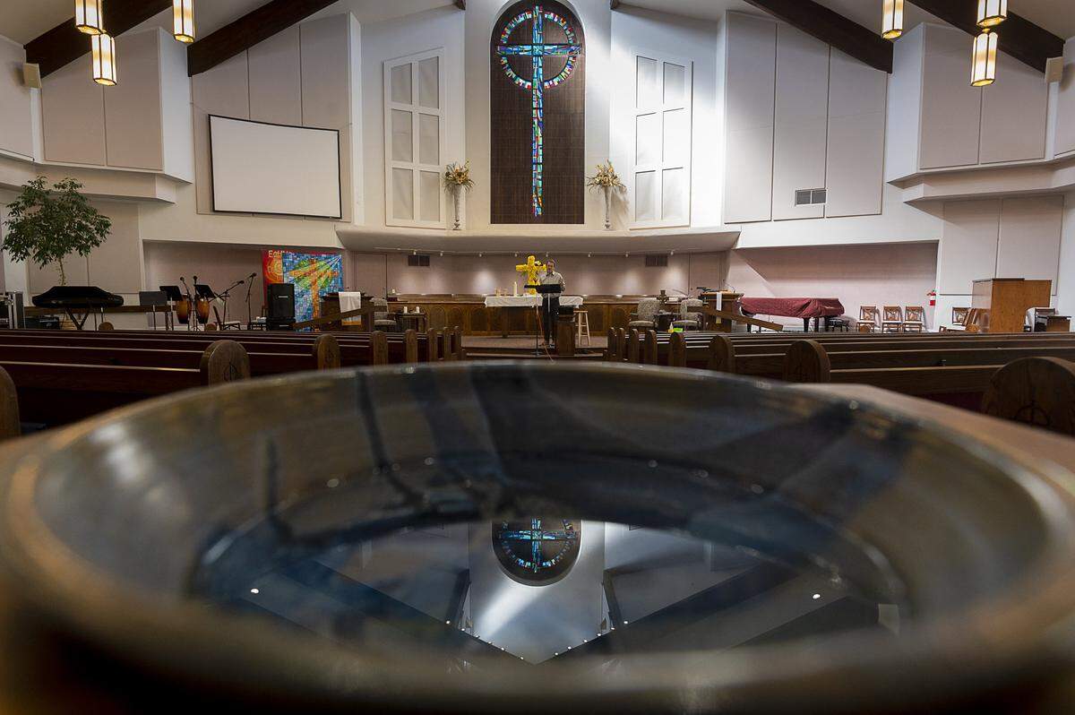 Pastor Jeff Chapman of Faith Presbyterian Church performs an online service to an empty chapel Sunday, April 26, 2020 in Sacramento. After the death of two church members and positive coronavirus tests for six others, Faith Presbyterian Church in Sacramento’s Greenhaven neighborhood is moving forward with online services, classes and prayer.