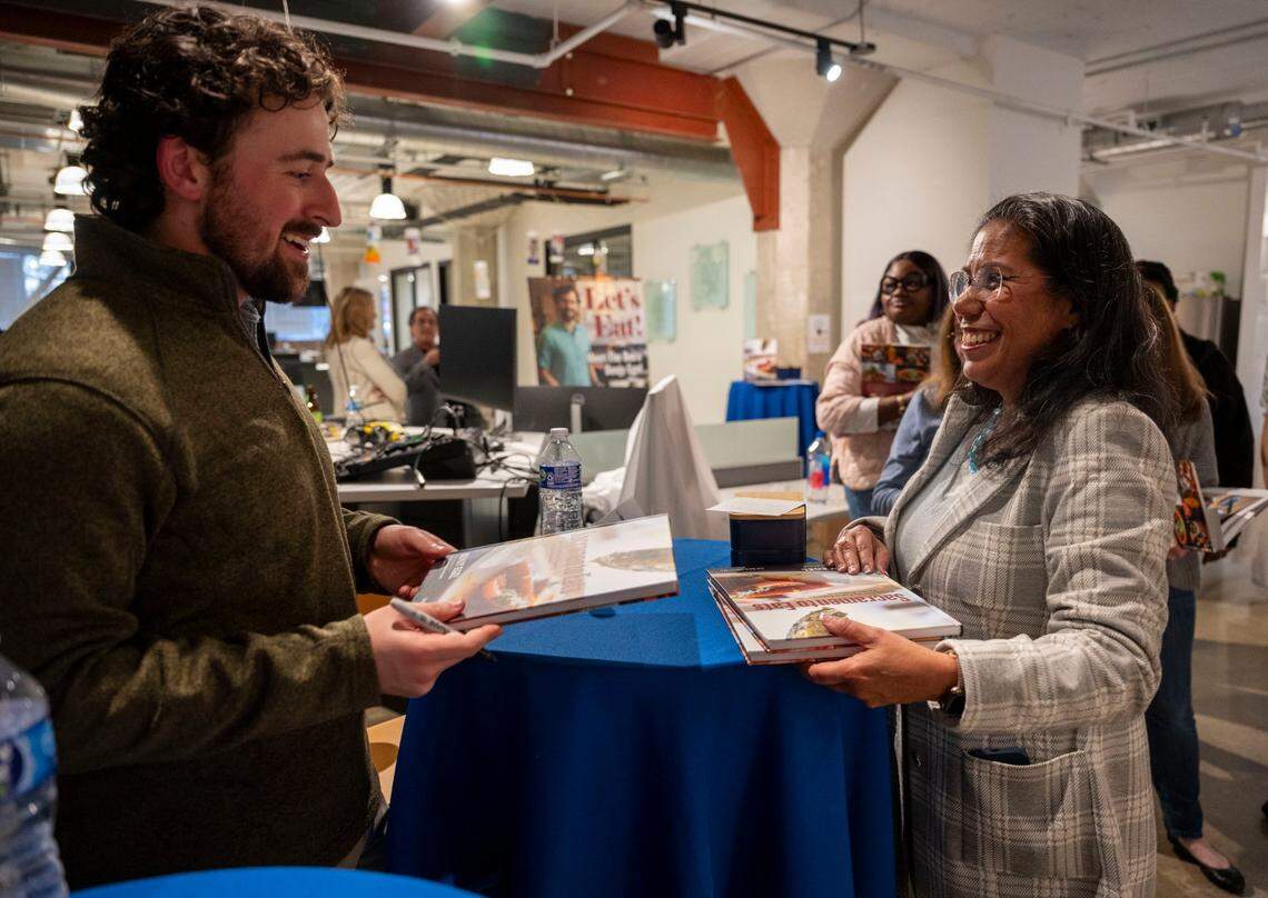 “Sacramento Eats” cookbook author and Bee food writer Benjy Egel, signs books for West Sacramento Mayor Martha Guerrero during The Sacramento Bee’s News & Nosh event on Tuesday, March 26, 2024.