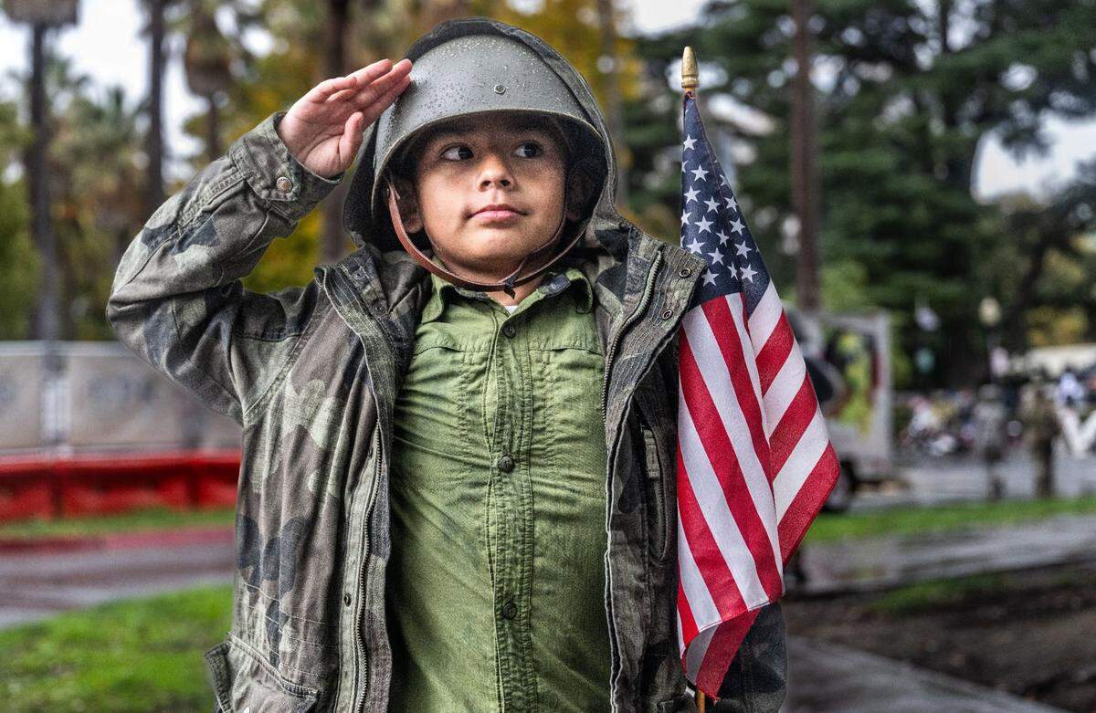 Micheal Erhard, of Sacramento, salutes after he watched the Veterans Day Parade in Sacramento on Monday, Nov. 11, 2024. Michael is a direct descendant of two men with wartime service: Martin Lujan, who served in World War I, and Joaquin Miranda, who served in the Korean War.