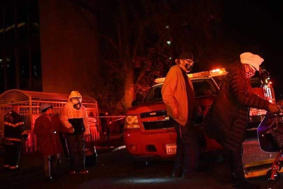 Residents of the Edgewater senior apartment tower in downtown Sacramento are evacuated by Sacramento Fire Department personnel on Tuesday, Dec. 14, 2021. The Edgewater and another high-rise residential tower were evacuated several hours after power to the buildings was severed by a nearby substation fire.