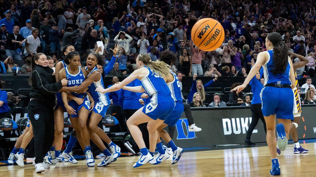 Duke Blue Devils guard Ashlon Jackson is surrounded by teammates after her game-winning basket over the Louisiana State University Tigers during the NCAA Women’s Basketball Tournament Sweet 16 game at Golden 1 Center in Sacramento on Friday.