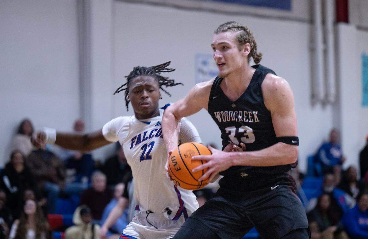 The Woodcreek Timberwolves’ Max VanLaningham (33) muscles his way past the Christian Brothers Falcons’ Grayson Stockdale (22) in the first half Thursday, Jan. 9, 2025, in Sacramento. 