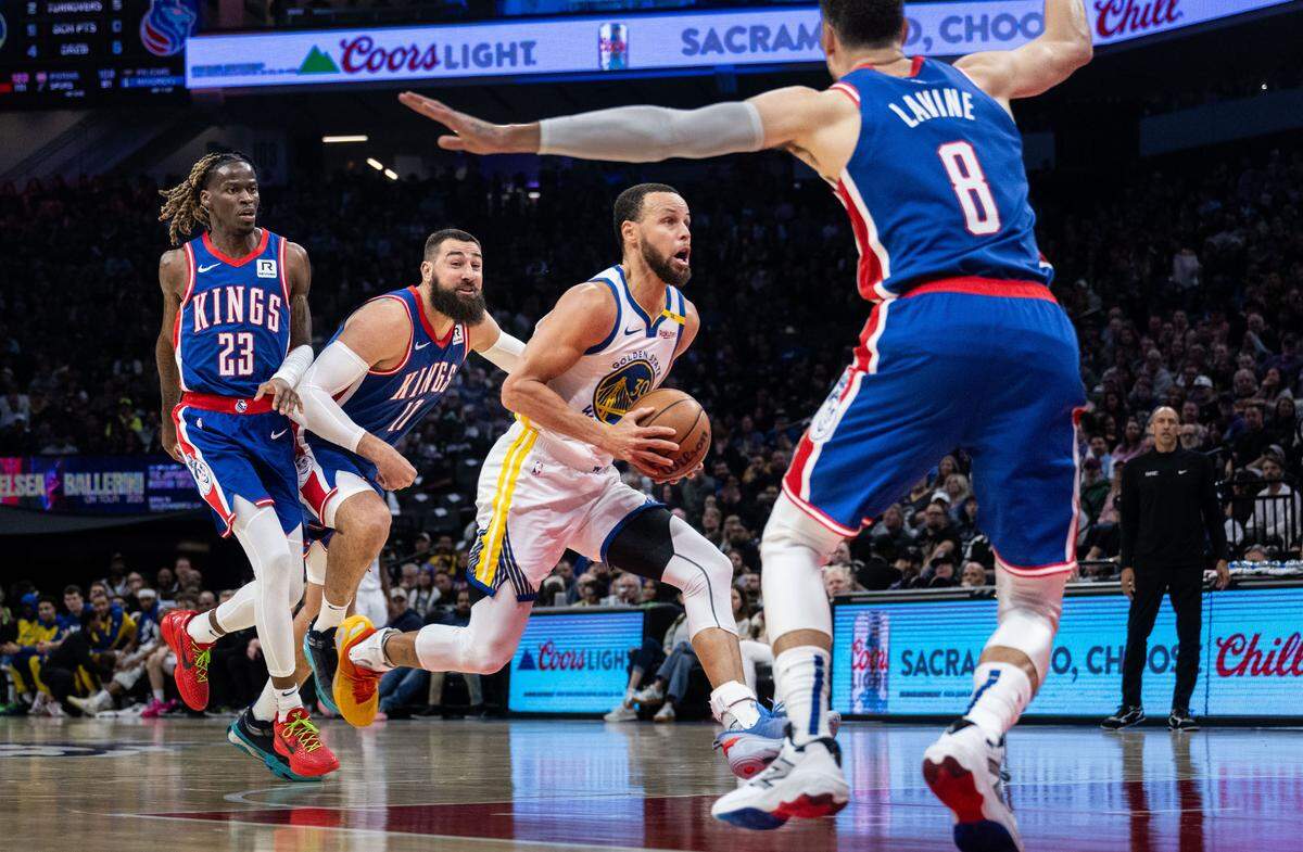 Golden State Warriors guard Stephen Curry (30) drives to the basket against Sacramento Kings guard Zach LaVine (8) during an NBA game on Friday, Feb. 21, 2025 at Golden 1 Center.  The Warriors are scheduled to play on Christmas.