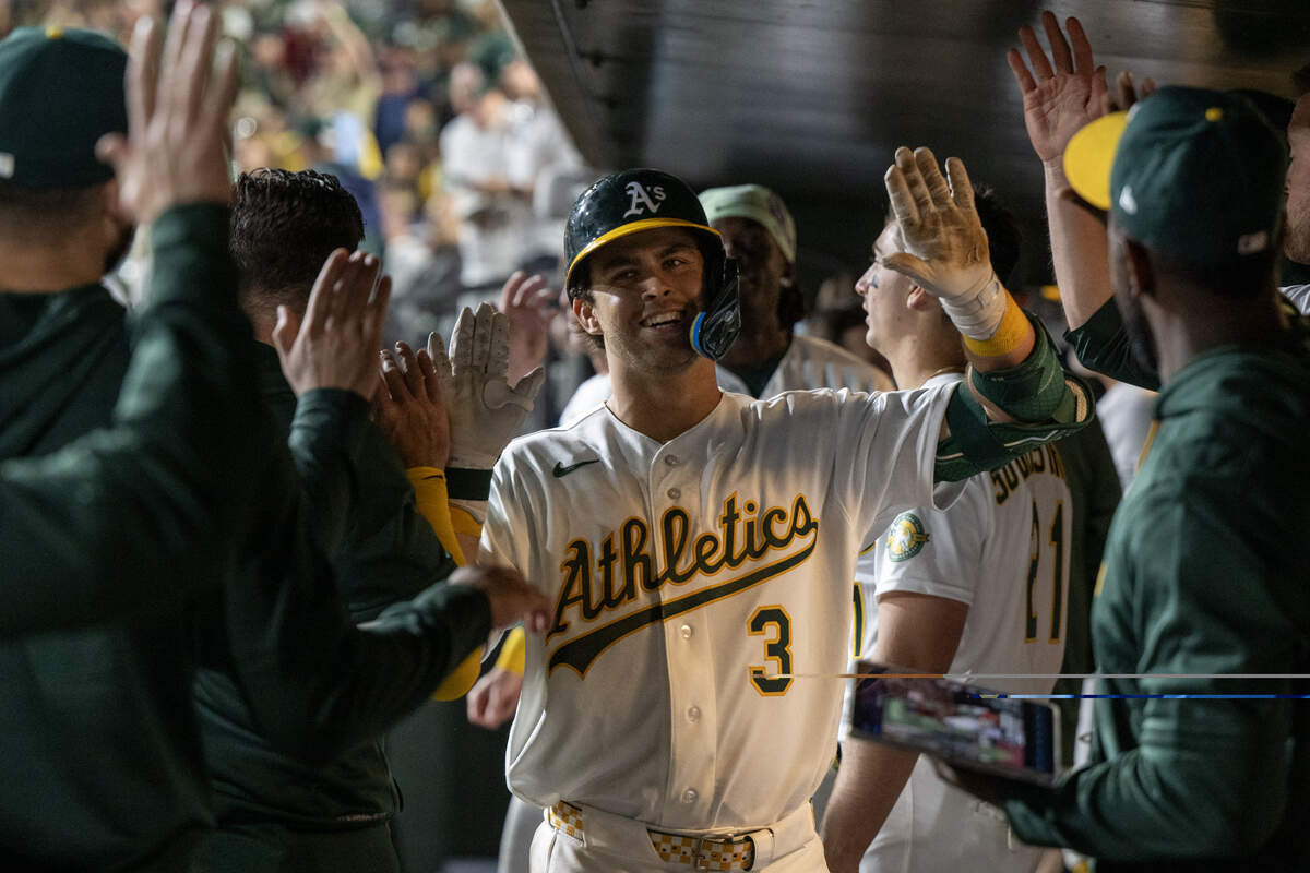 Athletics Max Muncy is greeted by teammates after hitting a home run in the bottom of the fourth inning against the Houston Astros on Friday, April 3 at Sutter Health Park in West Sacramento. He is in the midst of a rehab assignment and is expected to return to the A’s soon.