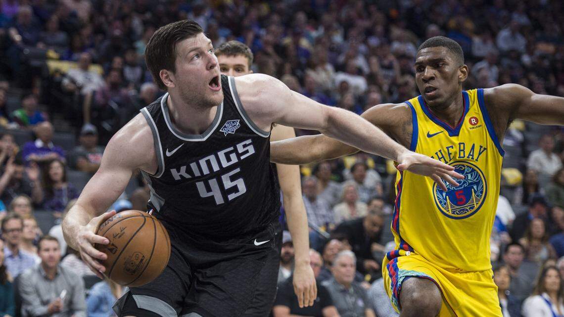 Kings forward Jack Cooley drives to the basket past Golden State Warriors forward Kevon Looney at Golden 1 Center on March 31.