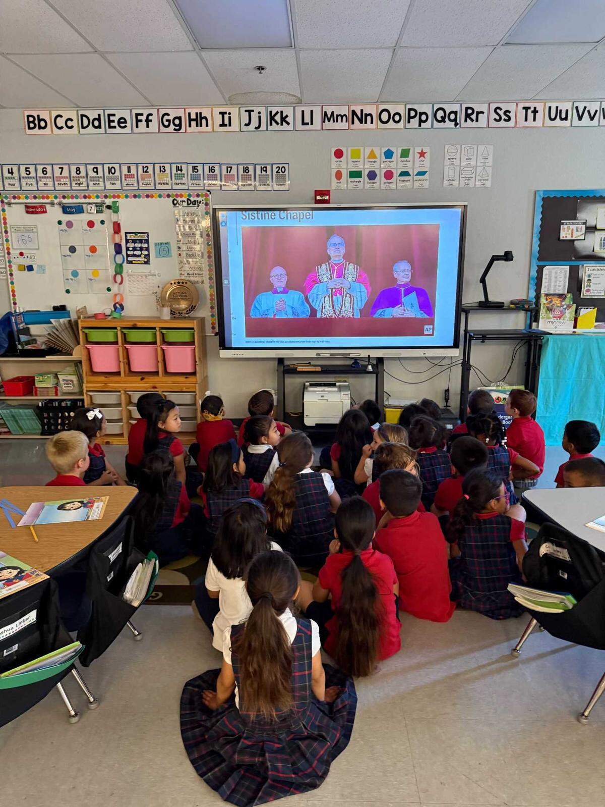 Kindergartners at St. Elizabeth Ann Seton Catholic School in Elk Grove watch the first public appearance of Pope Leo XIV on Thursday, May 8, 2025. For many pupils at the K-8 parochial school, it was their first time witnessing the selection of a new pope — this time, an American.