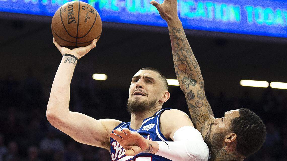 Sacramento Kings center Alex Len (25) is fouled by Philadelphia 76ers forward Mike Scott (1) during a game at the Golden 1 Center on Thursday, March 5, 2020 in Sacramento.