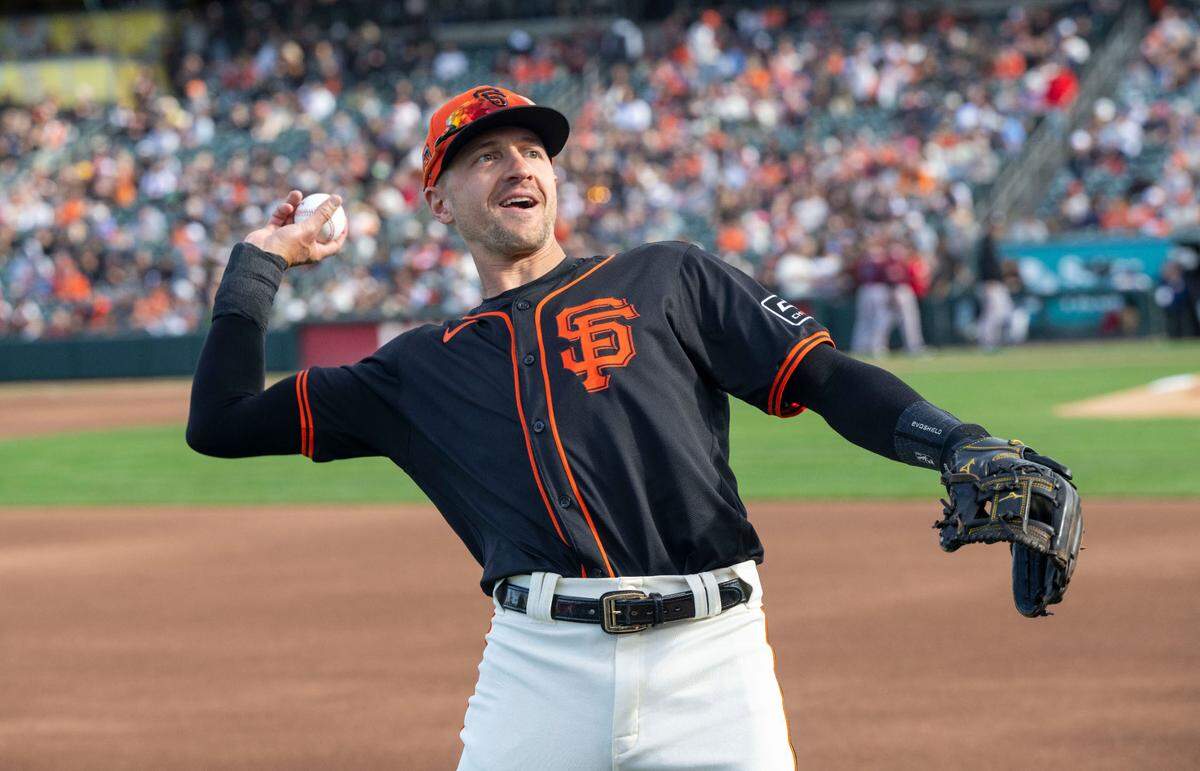 Nick Ahmed of the San Francisco Giants throws a ball up to the stands to a sold-out crowd at Sutter Health Park during an exhibition game with the Sacramento River Cats on Sunday.