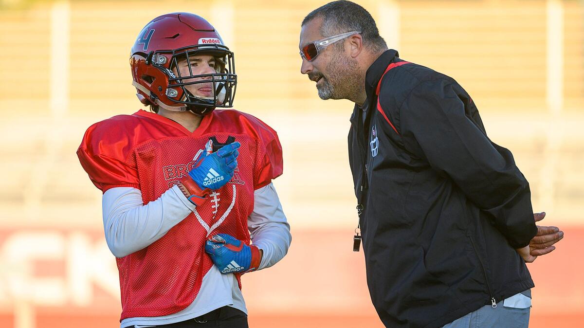 Coach Justin Reber talks to Logan Richards during practice at Bella Vista High School on Tuesday Oct. 1, 2019, in Fair Oaks.