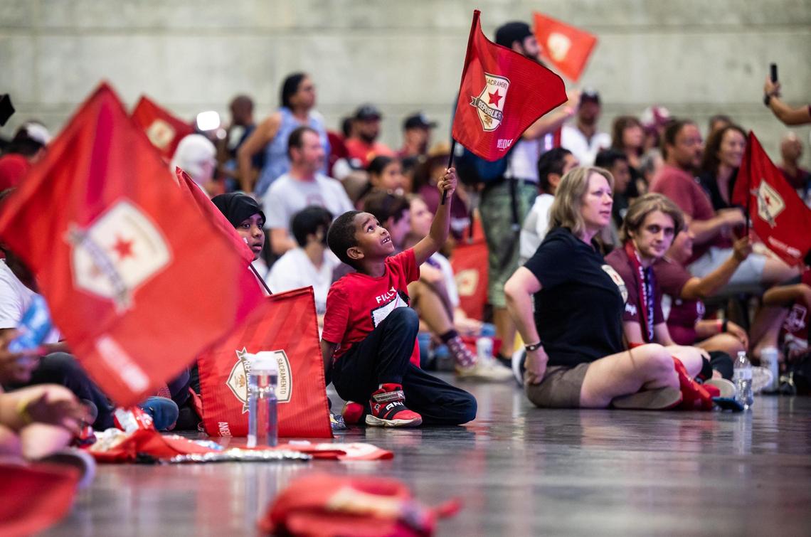 Munif Beshir, 7, waves a Sacramento Republic FC flag during a U.S. Open Cup final watch party at SAFE Credit Union Convention Center on Wednesday, Sept. 7, 2022, in Sacramento. Thousands of fans watched from the new venue as Sacramento kept the majority of the game against Orlando City SC tied at nil at Exploria Stadium in Orlando, only to fall 3-0 in the waning minutes of the game.