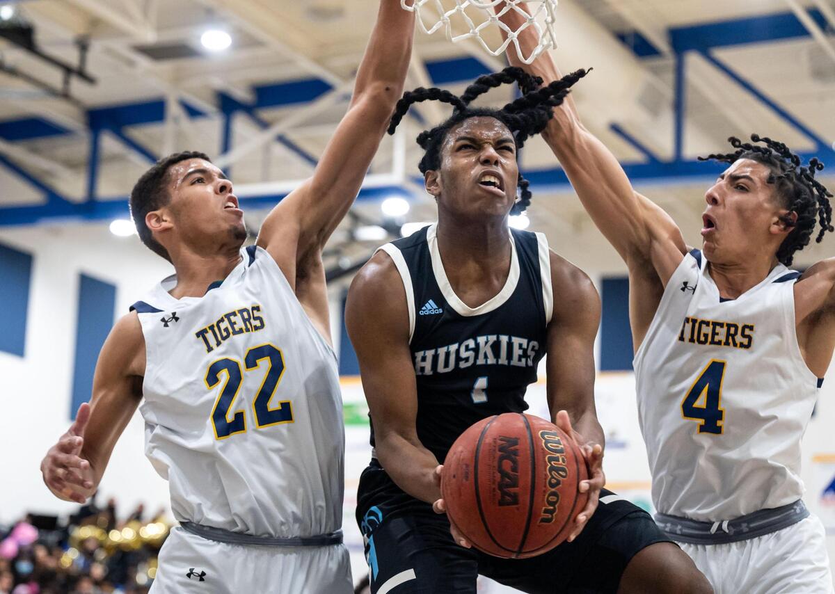 Sheldon Huskies’ Donovan Morgan (1) makes the shot and is fouled while going up against Inderkum Tigers’ Logan Steuben (22), left, and Jalen Glenn (4) during the first period of high school boys basketball Sac-Joaquin Section Division I semifinal playoff game Wednesday, Feb. 23, 2022, at Inderkum High School in Sacramento. Sheldon beat Inderkum, 85-80, to advance to the title game.