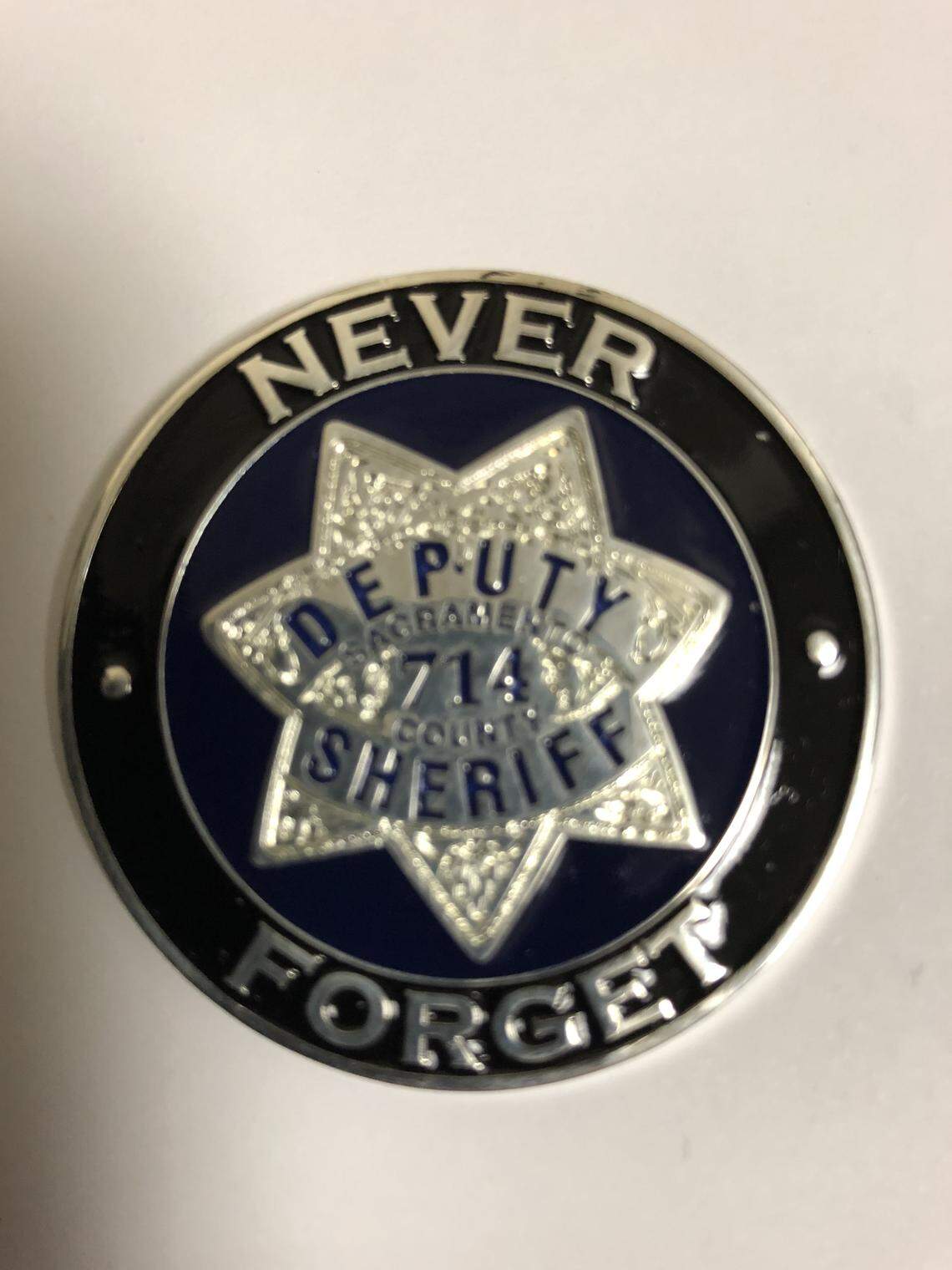 A coin commemorating slain Sacramento sheriff's Deputy Danny Oliver that his family carries at court hearings.
