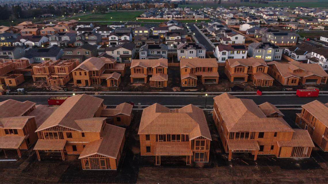 Homes under construction line Fortaleza Avenue in the foreground, with more complete homes behind them, as seen in a drone photo Wednesday, Nov. 17, 2021, in the Madeira Meadows development on the southern side of Elk Grove.