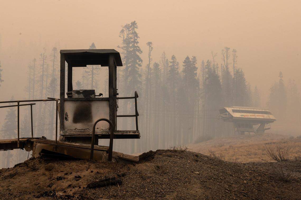 A burned control booth stands amid smoke at the Sierra- at-Tahoe ski resort after the Caldor Fire burned through the area on Monday, Aug. 30, 2021. The resort used snow blowers to spray water to protect its structures, most of which were saved.