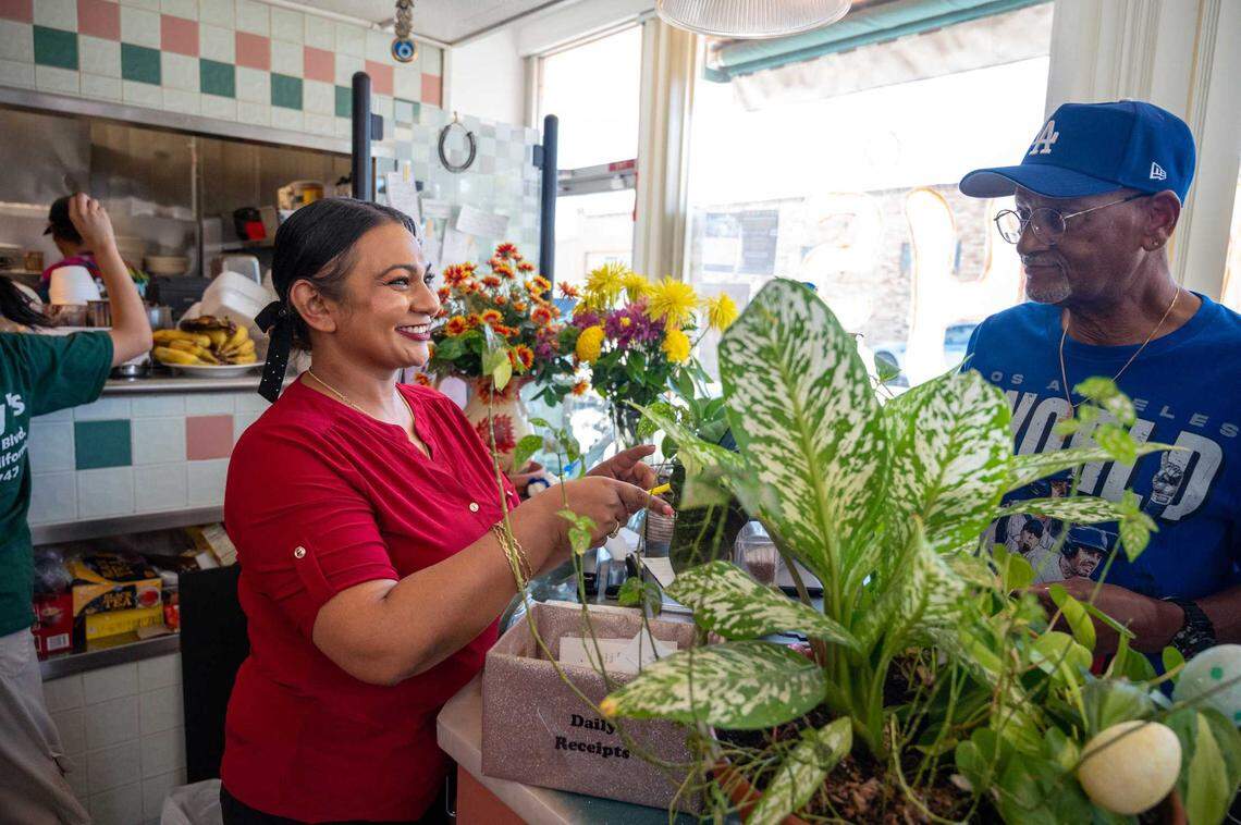 Sammy’s Restaurant owner Naz Begum rings up a customer during the diner’s first anniversary celebration since reopening after the pandemic on Saturday, July 19, 2025. She and her mother, Moon, brought the diner back to life after it had closed during the pandemic.