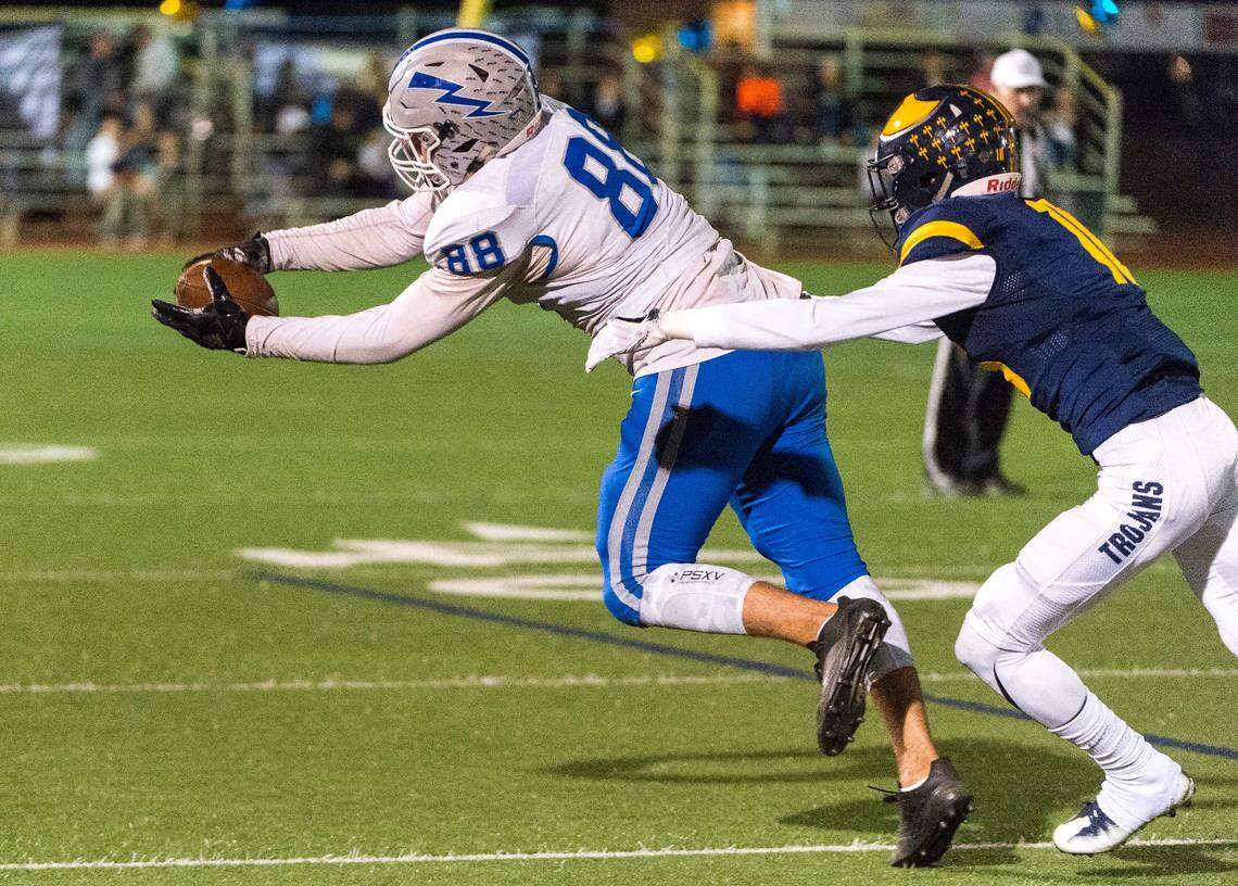 Rocklin’s Charlie McBride makes a catch as Oak Ridge’s Sawyer Merrill defends on Oct. 6, 2017.