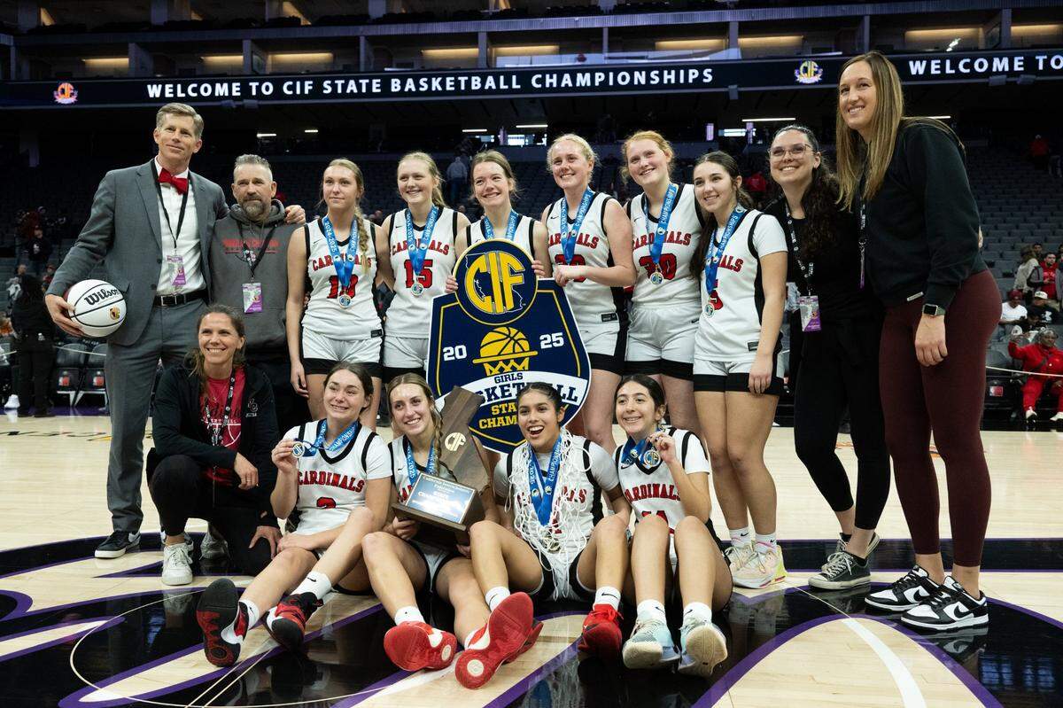 The Woodland Christian Cardinals celebrate after beating the Rosamond Roadrunners 47-41 during the CIF Division V State Championship girls basketball game at Golden 1 Center on Friday.