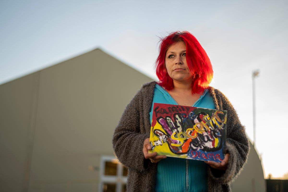 The Meadowview Navigation Center is asking the Book of Dreams to fund art supplies this holiday season. Micaela Partida holds her image, “Sacrifice,” outside of the center on Monday, Nov. 23, 2020.