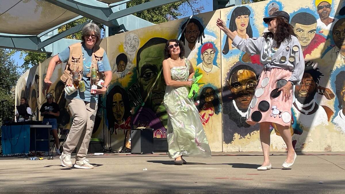 Participants of the “trashin’” fashion contest dance at the Sacramento Climate Festival at McClatchy Park in Oak Park on Saturday. These designers showcased garments made out of or including recycled materials.