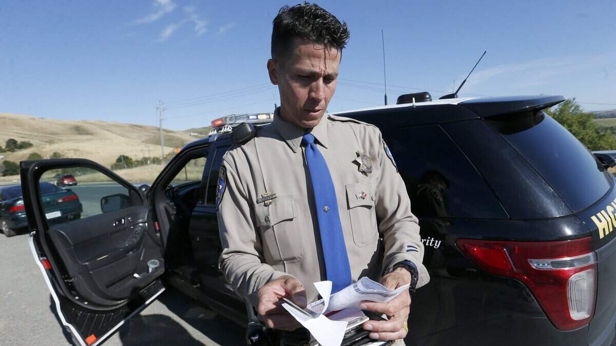 ANTIOCH, CA - MAY 28: California Highway Patrol officer Brandon Correia writes a ticket after a motorist violated the carpool lane rule along Highway 4 near Antioch, Calif., on Tuesday, May 28, 2019. The Metropolitan Transportation Commission is exploring app-based technologies that pair smartphones in a car or require users to take a picture of the occupants to verify who is in the car. (Jane Tyska/Bay Area News Group)