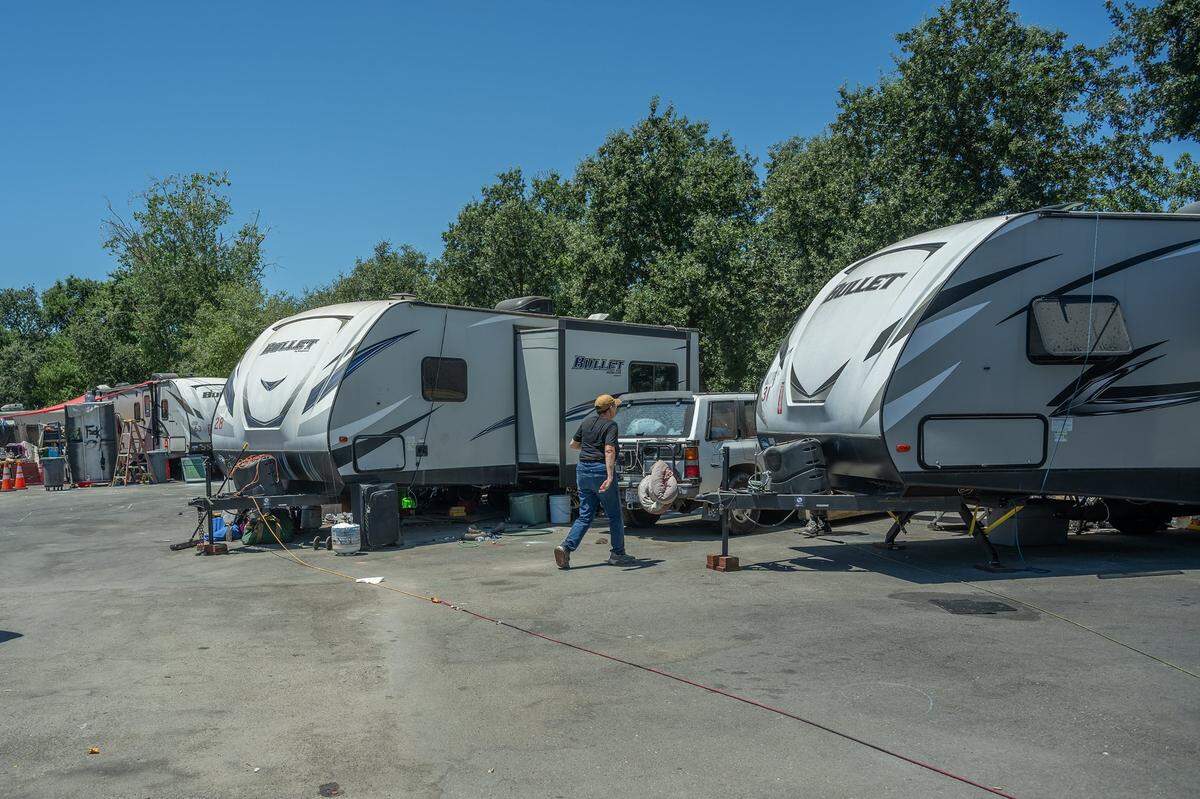 Sharon Jones makes her way to check on residents of Camp Resolution, a self governing homeless encampment during the extreme heat on Monday. She called the trailers the city has given them “death boxes,” as the heat inside them registered at 108 degrees about noon. “ It’s hot as hell and it’s not really getting any cooler in the next week or so and I’m afraid for some of these folks,” she said.