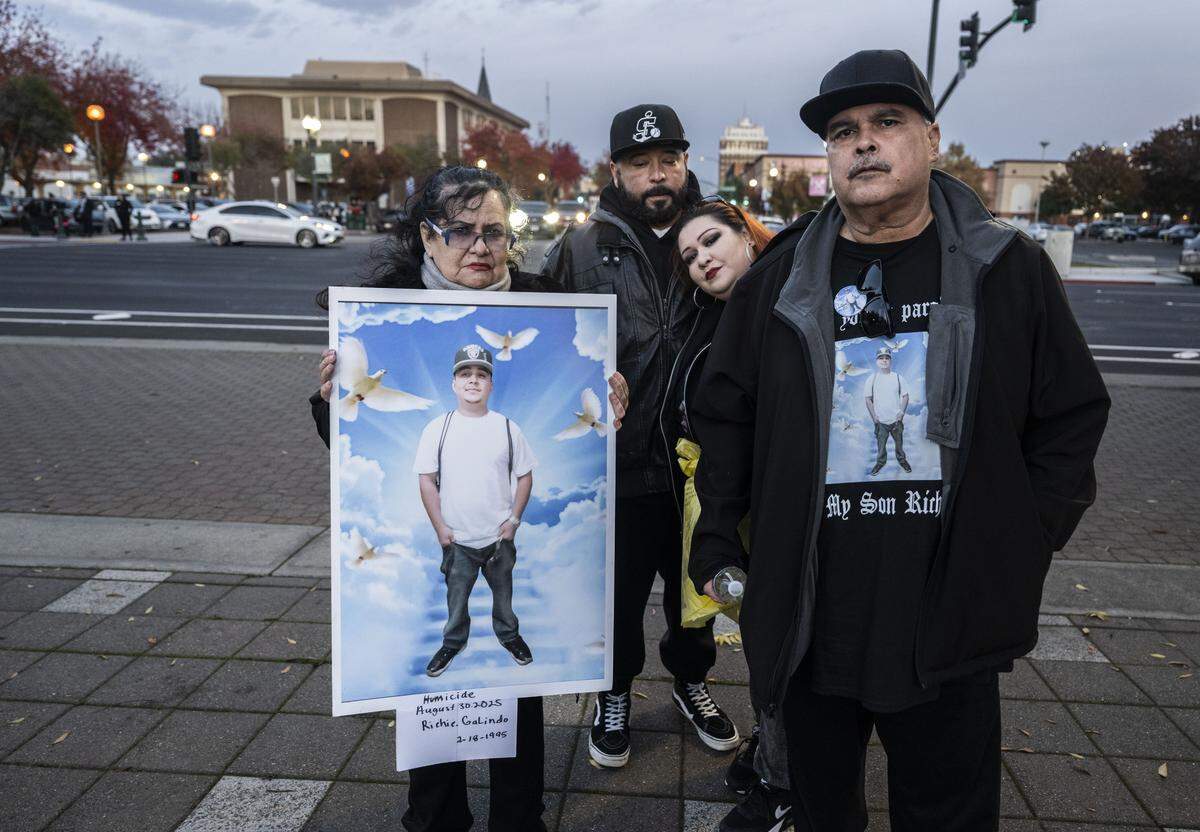 Graciela Galindo holds a photo of her son Richie, who was fatally shot in August, as she attends a Stockton candlelight vigil for victims of violent crime with her son Jose Arroyo, daughter Crystal Galindo and husband Richard Galindo on Wednesday. “People don’t care about killing people,” said Richard Galindo, a lifetime resident of Stockton.