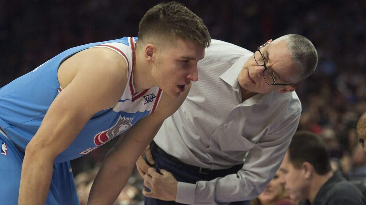 Pete Youngman, the Kings’ director of sports medicine, checks on guard Bogdan Bogdanovic during a game against the Chicago Bulls on Feb. 5 at Golden 1 Center in Sacramento. Youngman, a longtime team trainer, is stepping down from that role but will remain with the organization.