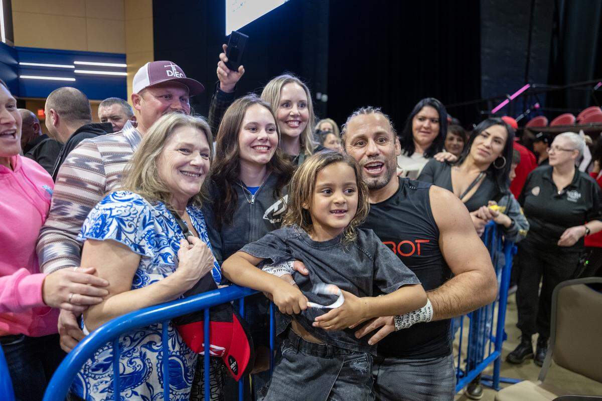 Urijah Faber holds his daughter Cali as he takes a photo with supporters at Hard Rock Hotel & Casino Sacramento at Fire Mountain near Wheatland on Friday, Jan. 30, 2026.