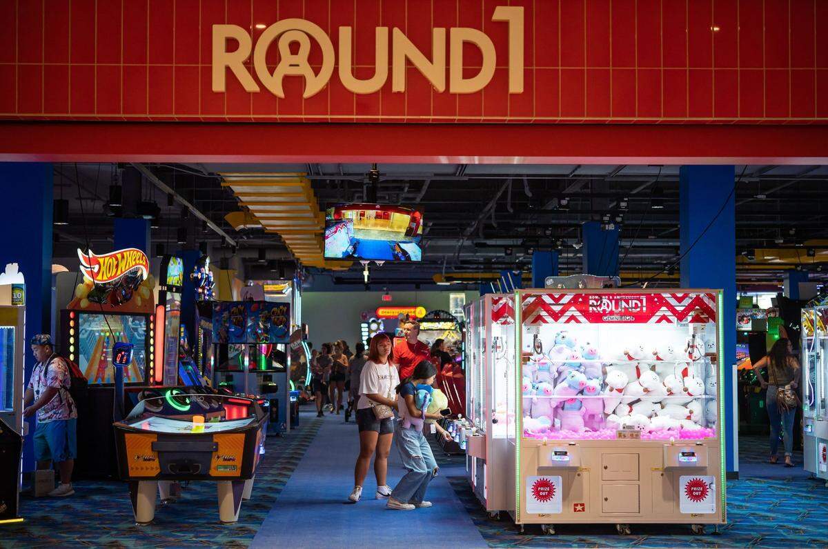 Customers explore Round1 Bowling & Amusement, seen from its mall entrance, on its opening Saturday, at the Westfield Galleria at Roseville in space formerly occupied by Sears.