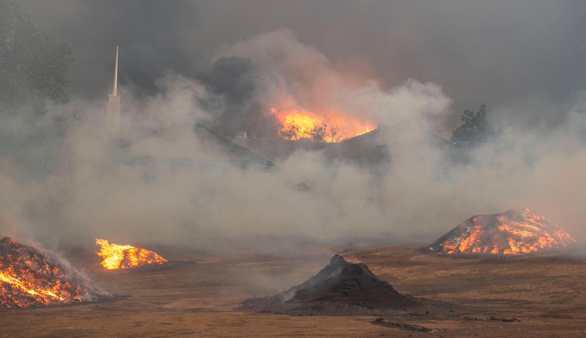 A fire burns around a church in Paradise during the Camp Fire on Thursday, Nov. 8, 2018.