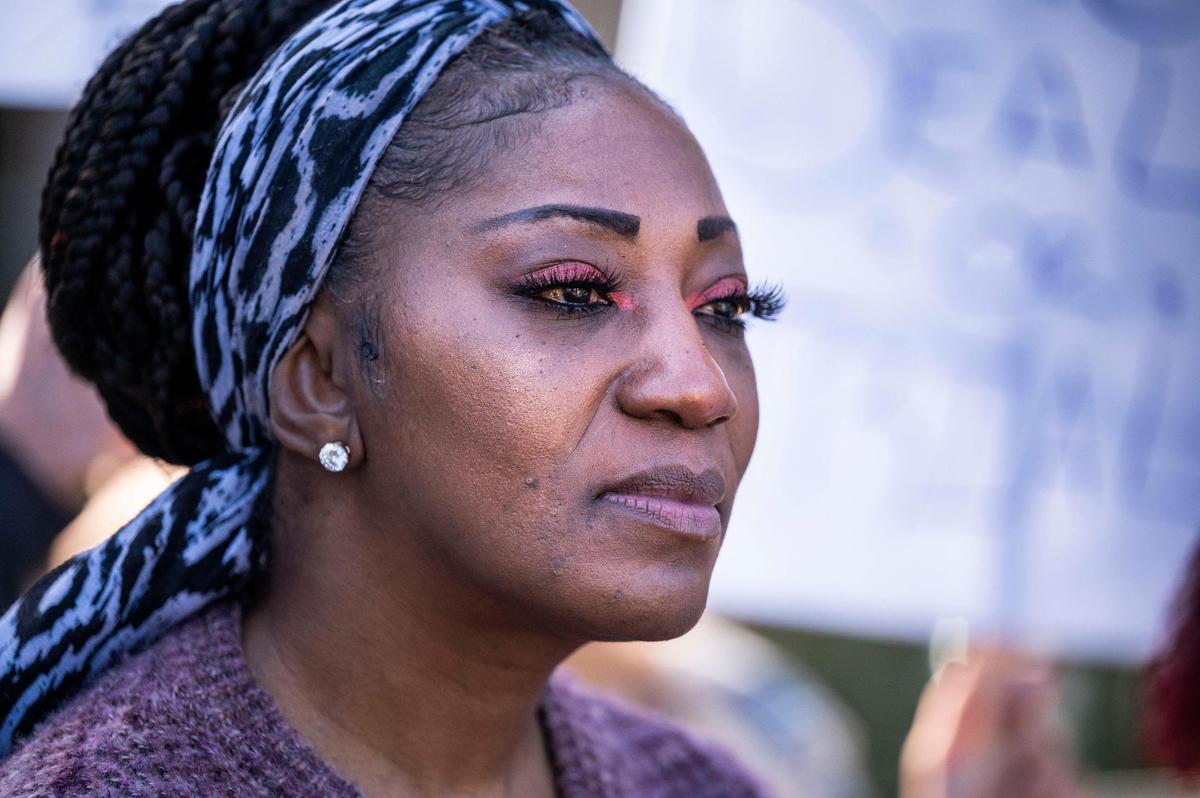 Tina Perry, of Sacramento listens to speakers in front of the El Dorado County District Attorney’s Office in Placerville on Monday, Jan. 31, 2022, as they talk about her son Harvest Davidson’s case who has been in jail in El Dorado County for six years.