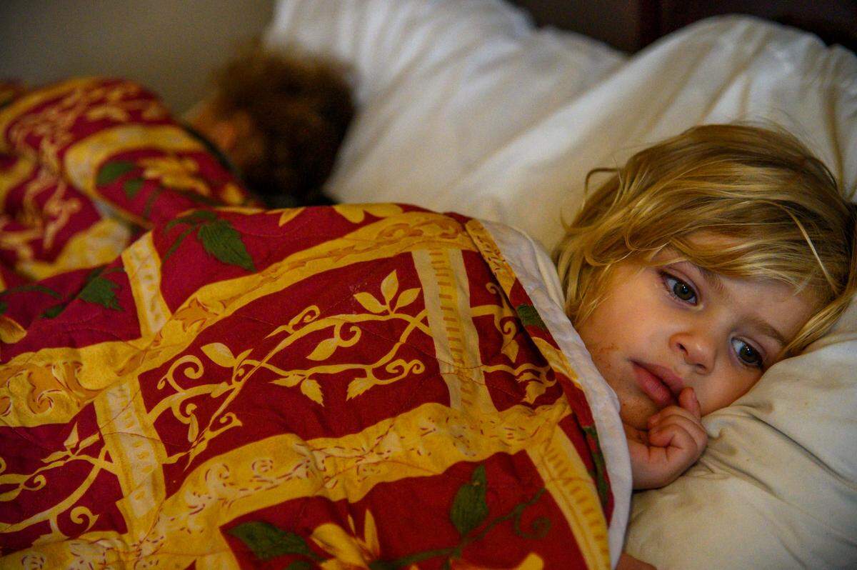 Kalaya Warren, 3, watches a cartoon on her mother’s computer as she and her brother London Velvaz, 1 1/2, take naps while staying at Americas Best Value Inn on Friday, Jan. 31, 2020 in Sacramento. The family was living in a car before getting a voucher from the Housing Support Program for a few days in the hotel. They were back living in their car and searching for housing the following week.