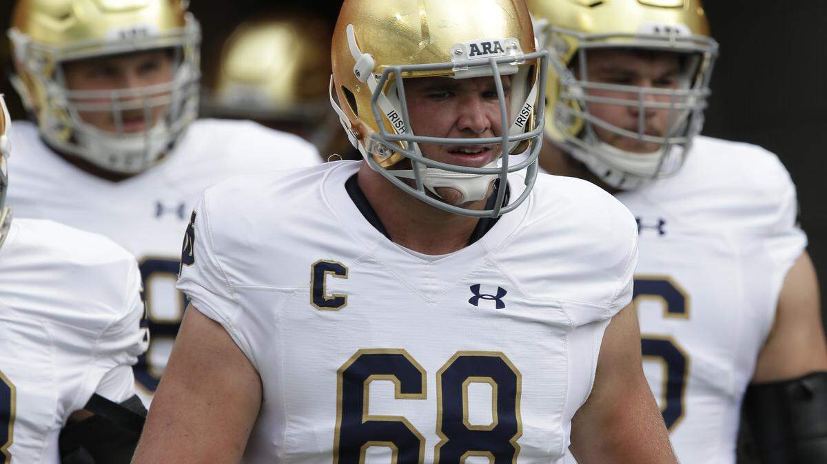 Notre Dame's Mike McGlinchey, center, takes the field prior to a game against North Carolina in Chapel Hill, N.C., on Oct. 7, 2017.