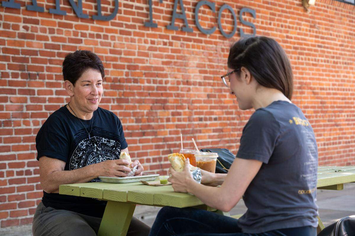Arlene Torres, left, and daughter Jenny Cera, right, eat breakfast tacos at Zoe Coffee and Tacos on Tuesday.