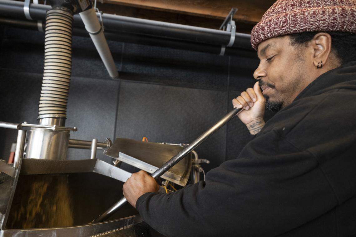 Rodg Little, co-owner and brewer at Oak Park Brewing, works on brewing a beer at the Sacramento brewery on Feb. 19.