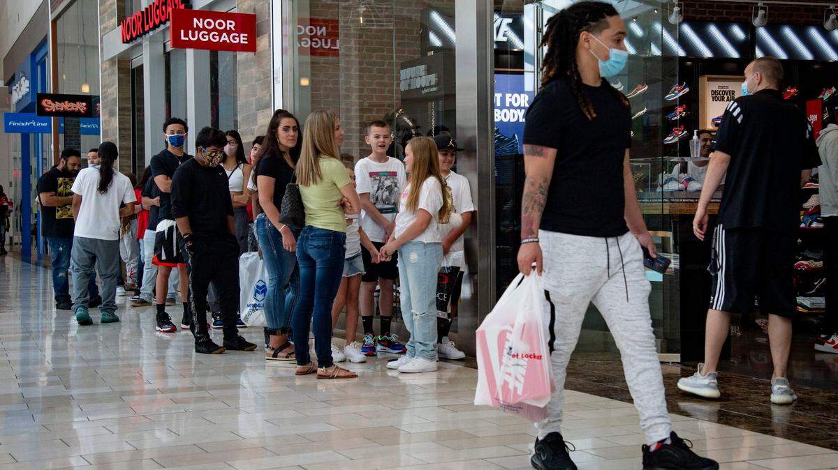 Shoppers stand on line to get into the Foot Locker inside the Westfield Galleria Mall in Roseville on Friday, May 22, 2020. California plans to end social distance and business capacity restrictions on June 15, 2021.