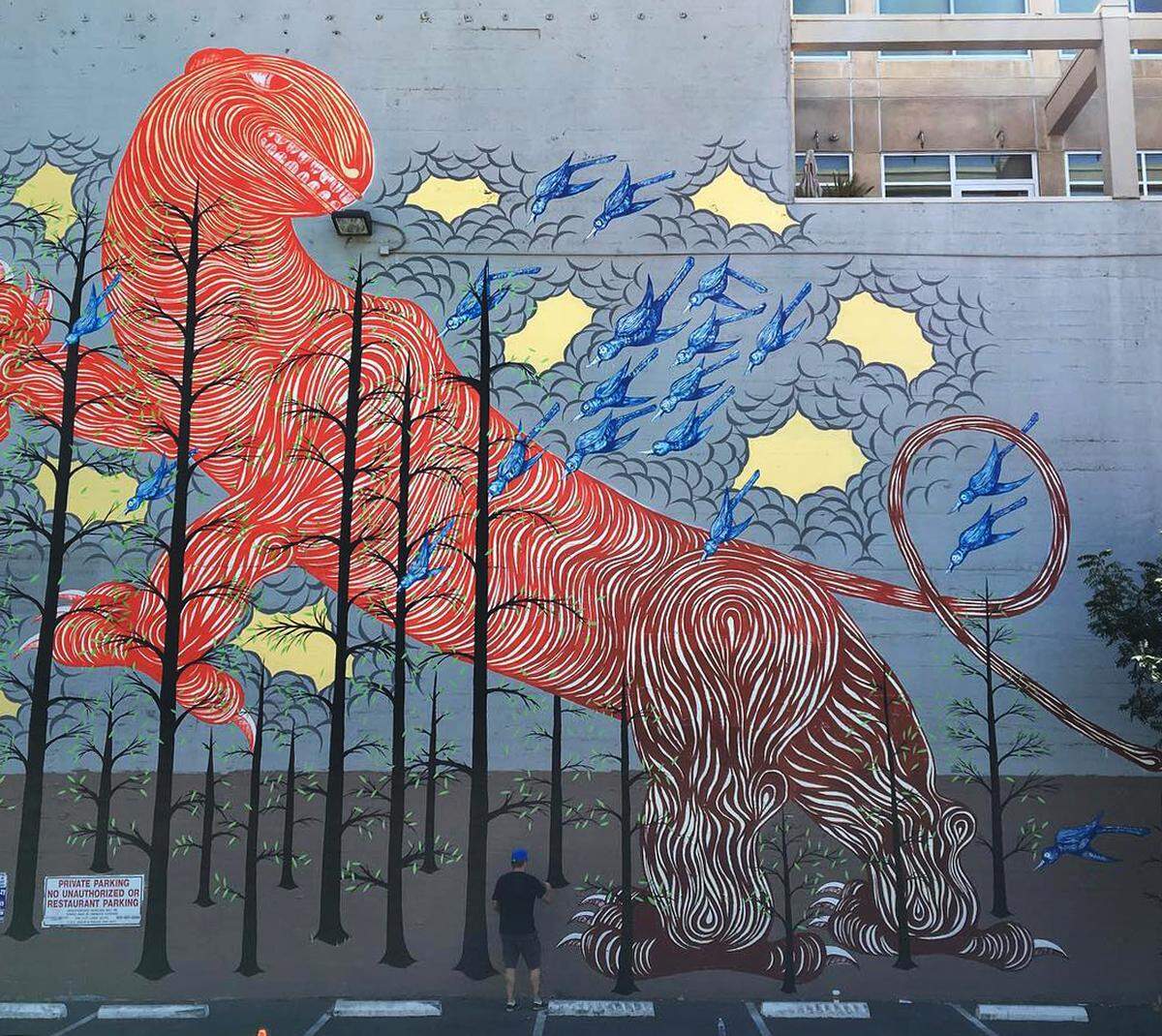 Artist Andrew Schoultz paints “The Birds and The Beast” in 2016, the first year of the Wide Open Walls festival (when it was known as the Sacramento Mural Festival), on the Elliot Building on J Street in downtown Sacramento. The mural was recently painted over.