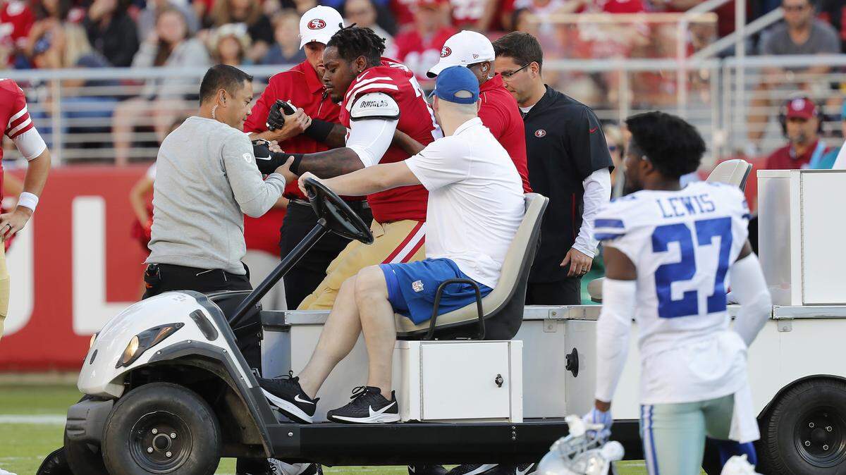 San Francisco 49ers offensive tackle Shon Coleman, center left, is helped onto a cart during the first half of the team’s NFL preseason football game against the Dallas Cowboys in Santa Clara, Calif., Saturday, Aug. 10, 2019. (AP Photo/Josie Lepe)