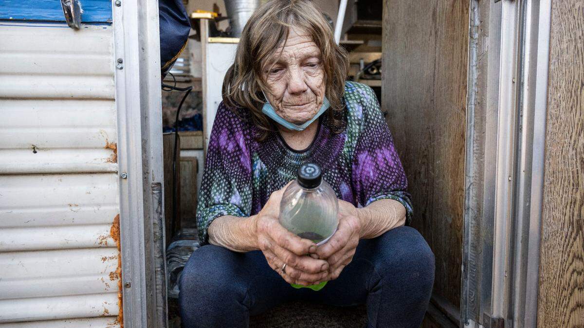 Sharon Foster, a 63-year-old former cab driver, sits in Nov. 2 in her recently purchased Ford camper at a homeless encampment on Colfax Street in North Sacramento. The camp is on city property that state officials have deemed too toxic for people to inhabit. Like other campers at the site, Foster has received a city notice to leave the area by Nov. 11.