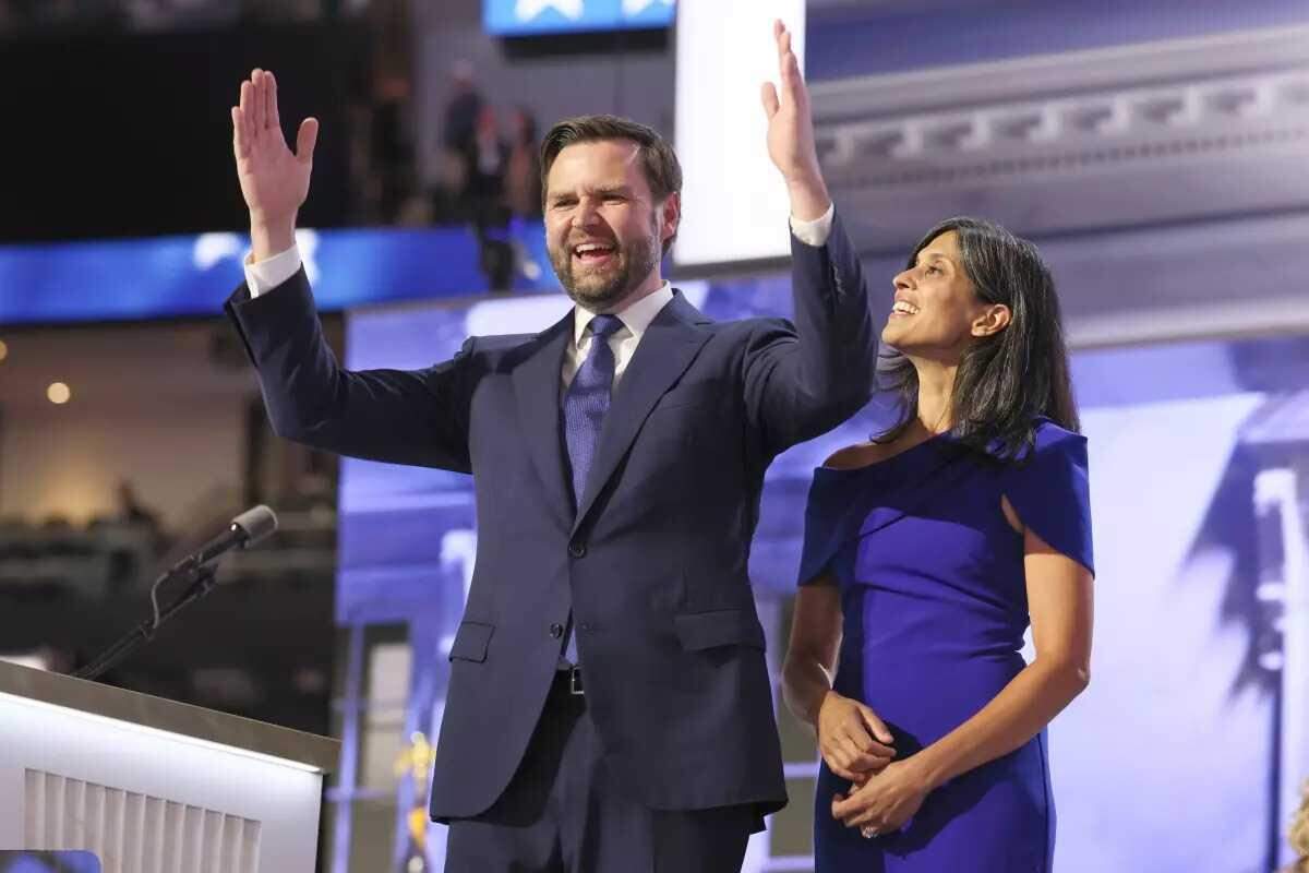 Vice presidential candidate J.D. Vance stands on stage with his wife, Usha, at the 2024 Republican National Convention. The two met while studying at Yale Law School.