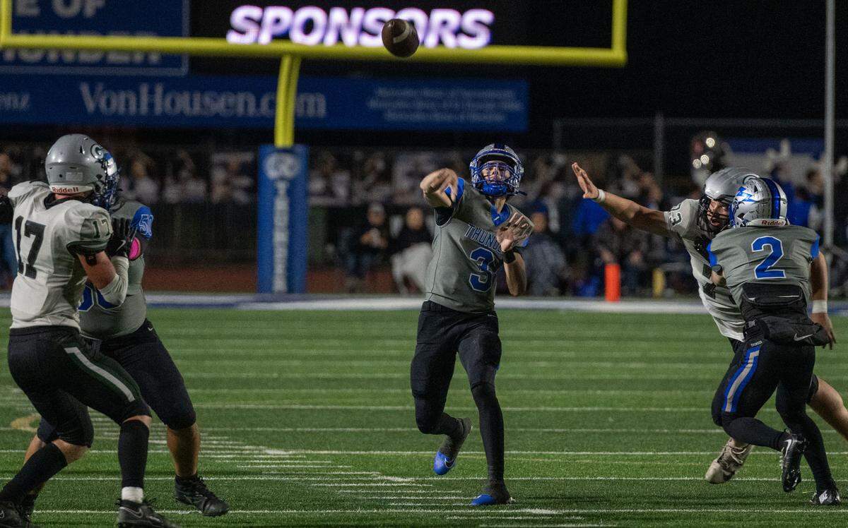 Rocklin Thunder quarterback Reeve Slone (3) throws a touchdown to tight end Keane Frank (12) as the Granite Bay Grizzlies’ Austin Valdez (73) applies pressure on Friday, Oct. 18, 2024, in Rocklin. 