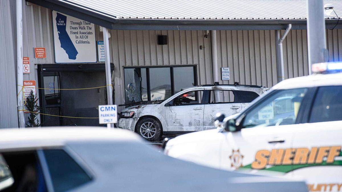 An SUV sits at the entrance of a Walmart distribution center in Red Bluff, Calif., on Saturday, June 27, 2020. A man drove the vehicle into the front of the building before police say he opened fire on workers. The suspect was shot by police minutes later. Two people were killed and four people were wounded in the attack.