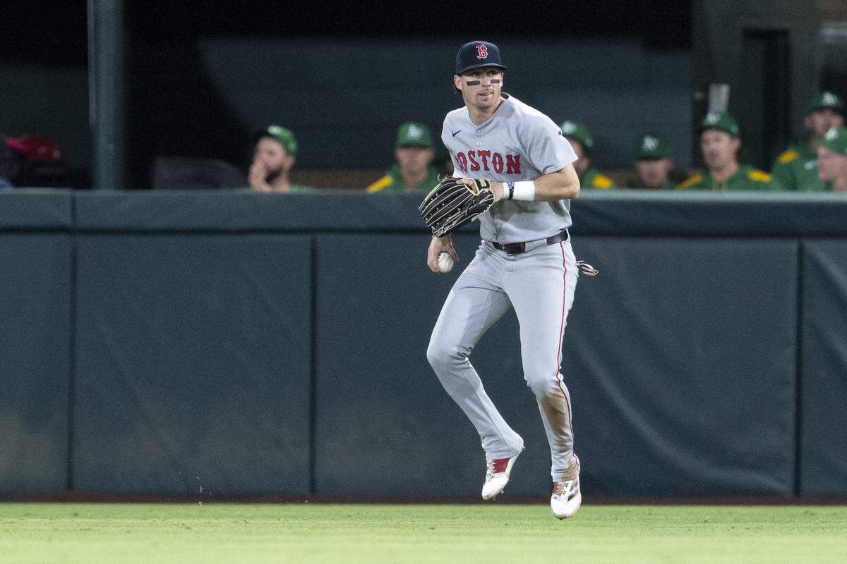 Boston Red Sox outfielder Nick Sogard (20) looks to throw the ball during a game between the Athletics and the Red Sox at Sutter Health Park in West Sacramento on Monday.