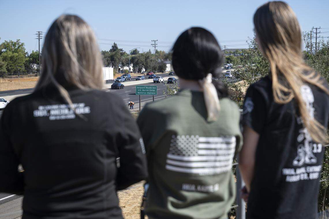 From left, Cheryl Juels, Marine Sgt. Nicole Gee’s aunt, Krista Juels, Gee’s cousin, and Thor Herrera, Gee’s brother, watch the unveiling of a sign dedicating a portion of Interstate 80 to Sgt. Nicole Gee, in Roseville on Wednesday. Gee, a Roseville native, was killed during the U.S. withdrawal from Afghanistan in 2021.