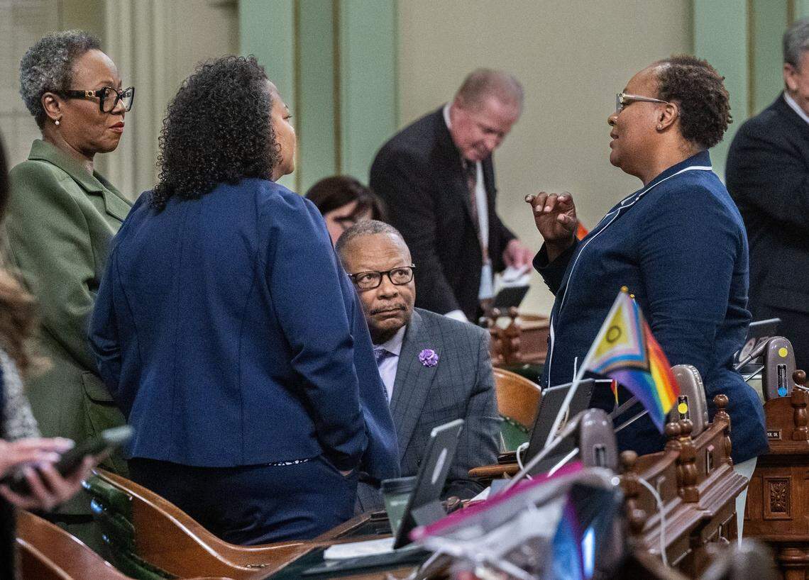 California Legislative Black Caucus chair Lori Wilson, D-Suisun City, right, talks with fellow Assembly Democrats Tina McKinnor of Inglewood, Mia Bonta of Oakland and Reginald Jones-Sawyer of South Los Angeles on Friday at the state Capitol.