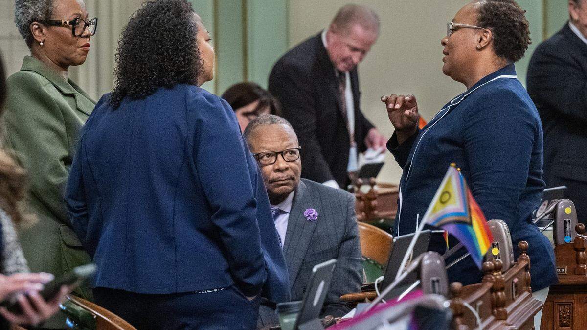 California Legislative Black Caucus chair Lori Wilson, D-Suisun City, right, talks with fellow Assembly Democrats Tina McKinnor of Inglewood, Mia Bonta of Oakland and Reginald Jones-Sawyer of South Los Angeles on Friday, Aug. 30, 2024, at the state Capitol.