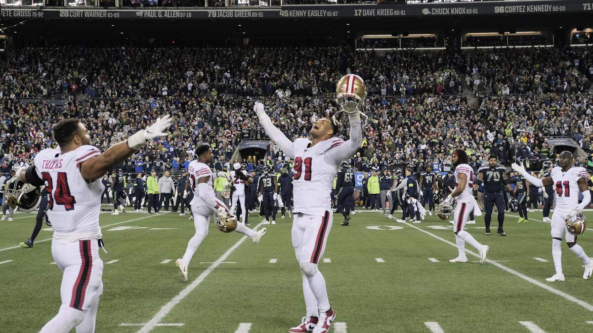 San Francisco’s Arik Armstead, an Elk Grove native, raises his arms in celebration as time expires in the team’s victory over the Seattle Seahawks on Sunday.