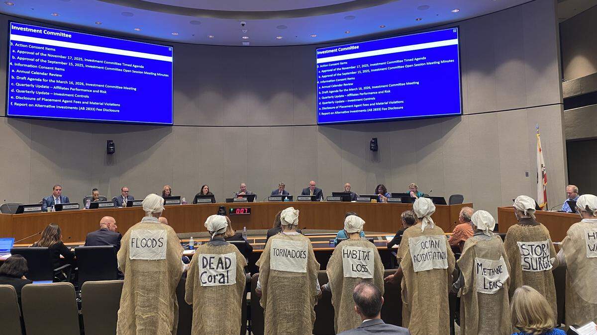 A group of protesters known as the “Climate Lamentors” stand in front of the CalPERS board of administration during an investment committee meeting on Monday, Nov. 17, urging the board to divest from fossil fuel companies.