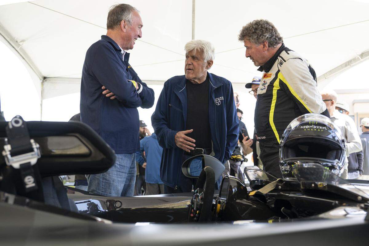 Comedian and car collector Jay Leno chats with Joe Huffaker, left, and driver Boris Said, right, as they look at the Dallara EXP car during the Velocity Invitational at Sonoma Raceway in Sonoma on Saturday.
