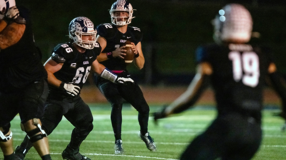 Casa Roble Rams quarterback Connor Campbell (12) looks downfield to find receiver Ethan Horner for a 72-yard touchdown reception in the first quarter against the Pioneer Patriots on Friday at Casa Roble High School in Orangevale.